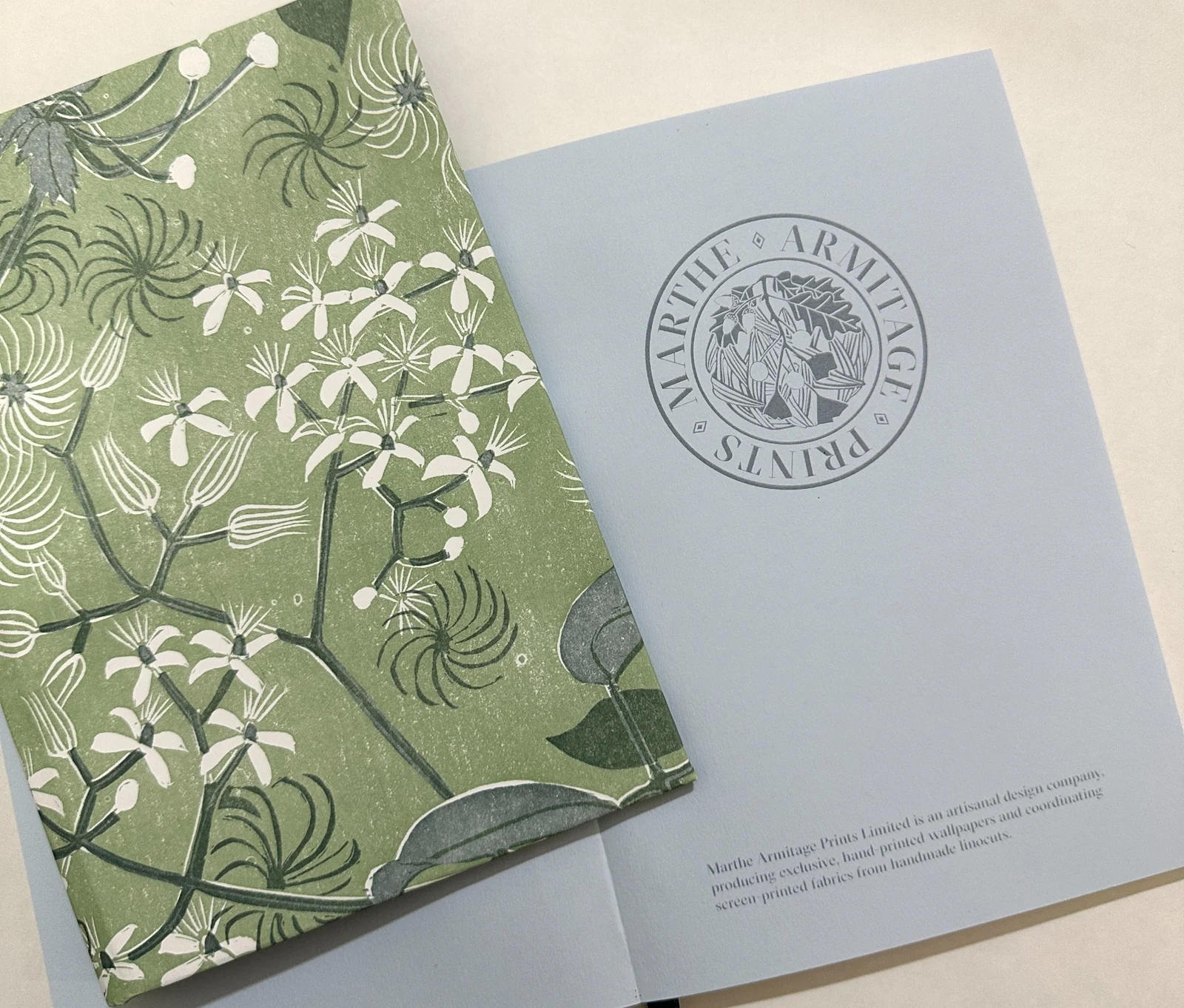 Green botanical journal shown with a printed branded endpaper