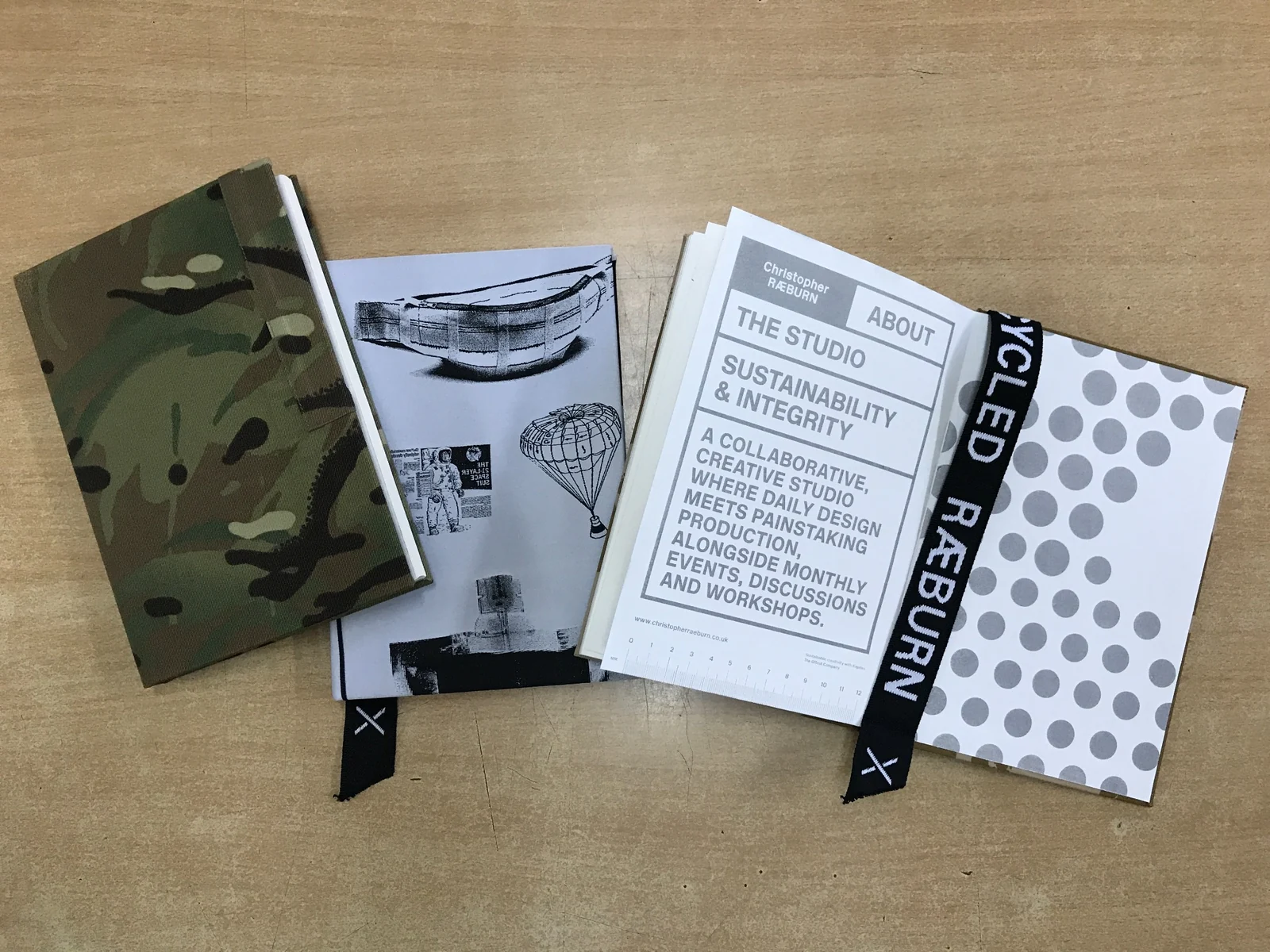 Journals with camouflage, monochrome graphics, text and spotted cover designs