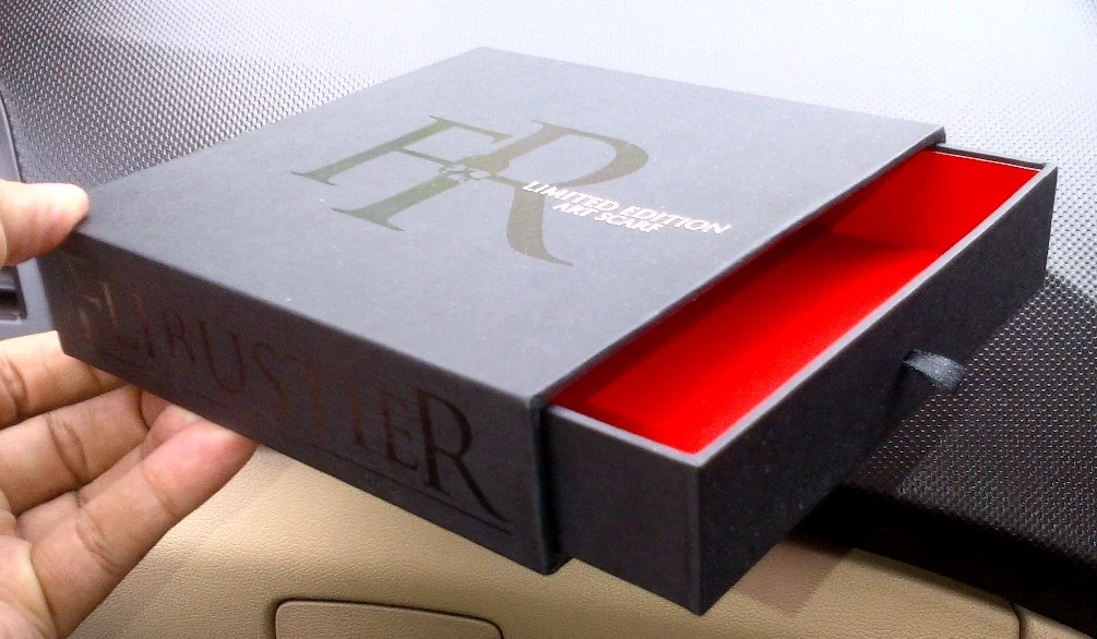 Grey monogrammed drawer box with a vivid red inner tray