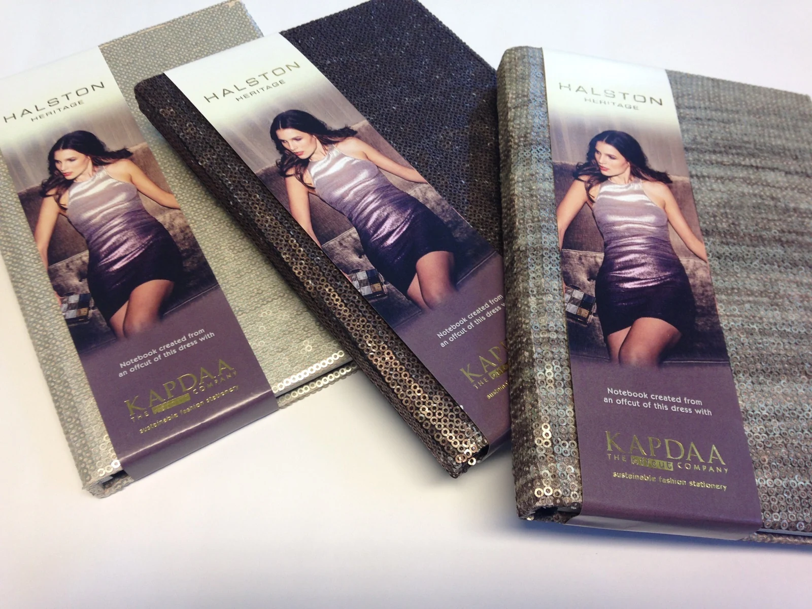 Textured journals with illustrated branded paper sleeves