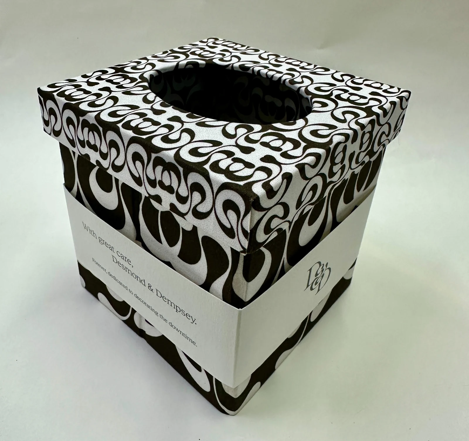 Black and white patterned tissue box cover with a circular top opening